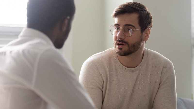 Man explaining to another man that CBD will not get you high, and debunking other CBD myths