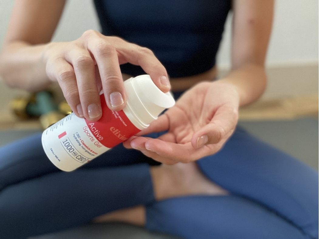 A person holding Active Sports Gel and pumping it into their hand