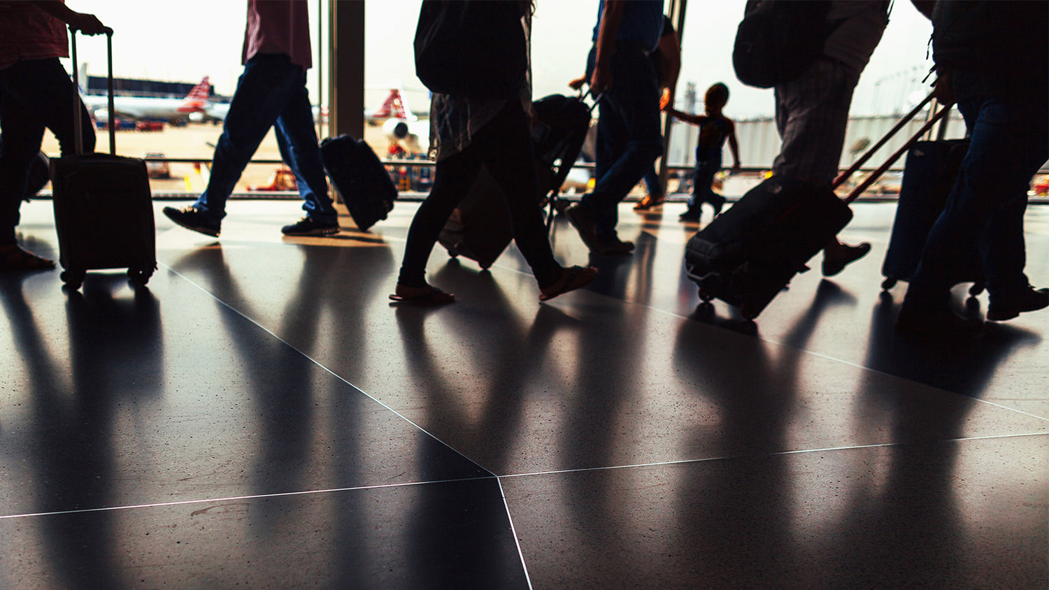 Travelers moving through an airport in the United States carrying legal CBD products.