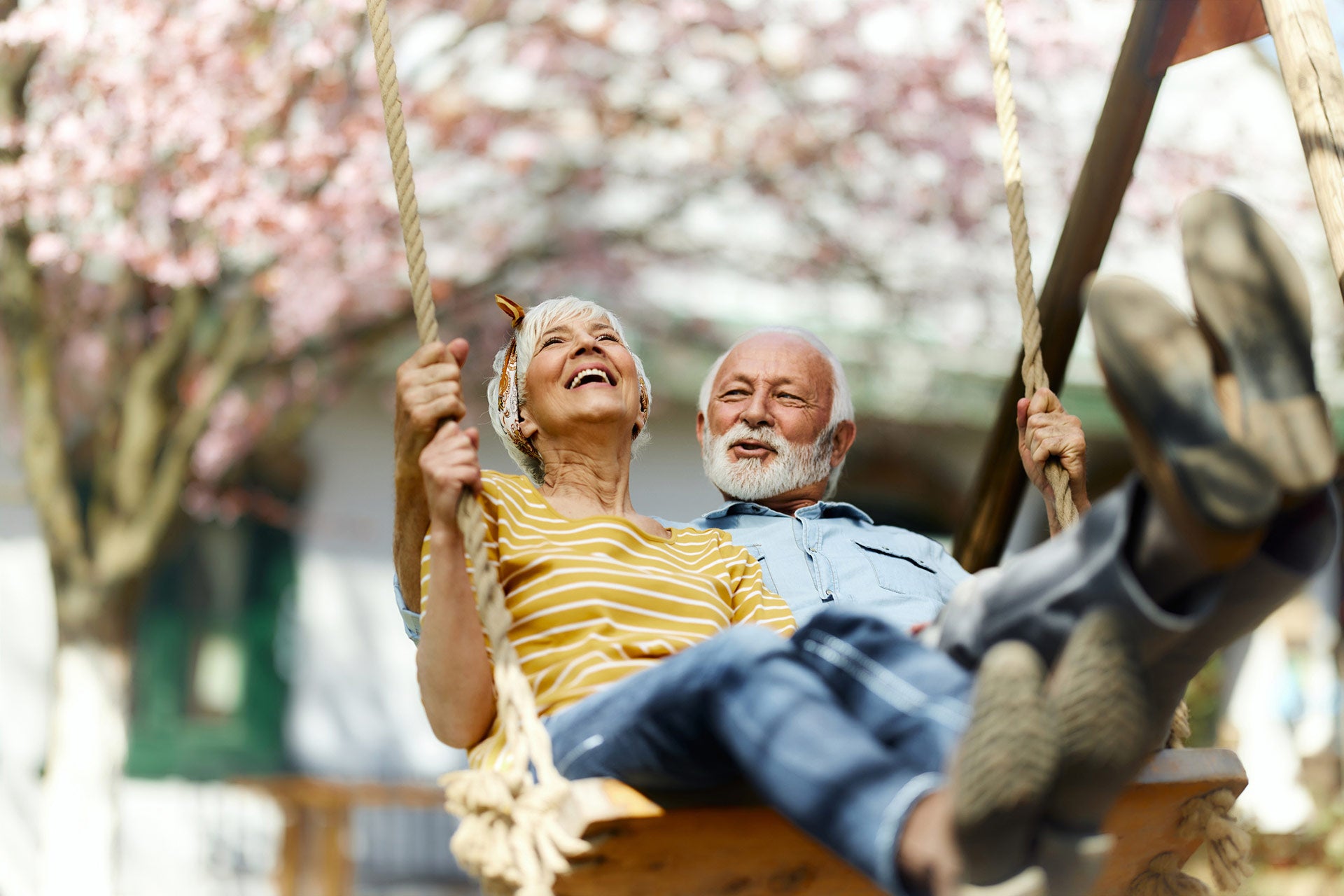 Couple enjoying an swing in the garden